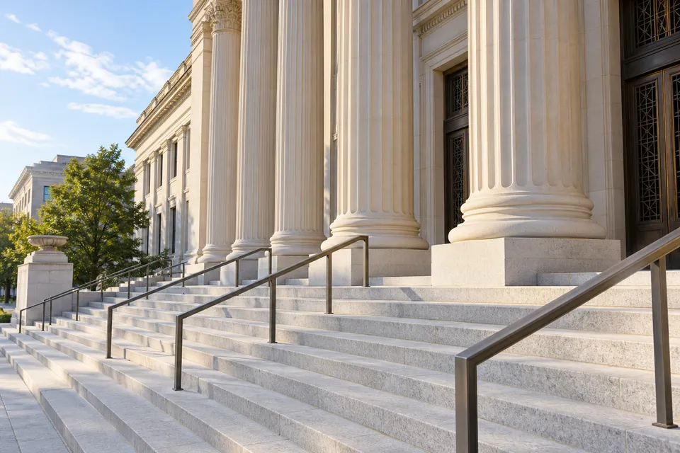 Illustrative campaign image: stone courthouse columns and steps in clear morning daylight.