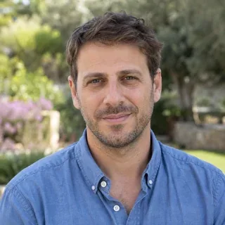 Temporary AI-generated placeholder portrait for Alon Regev