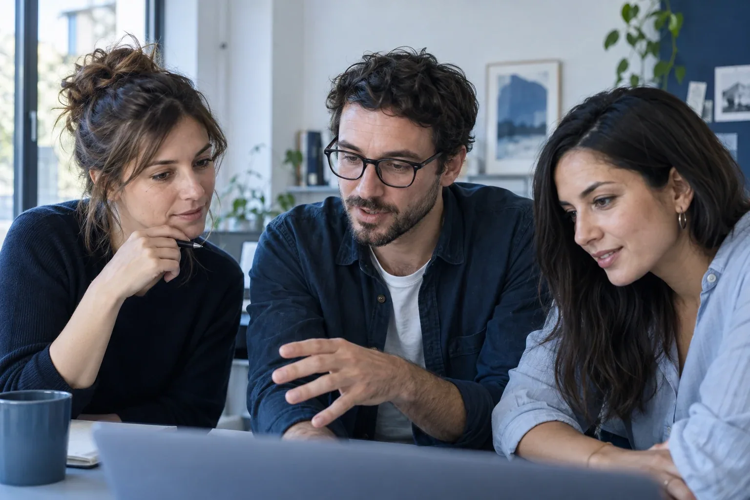 AI-generated scene of three marketing specialists discussing work around a laptop in an office.